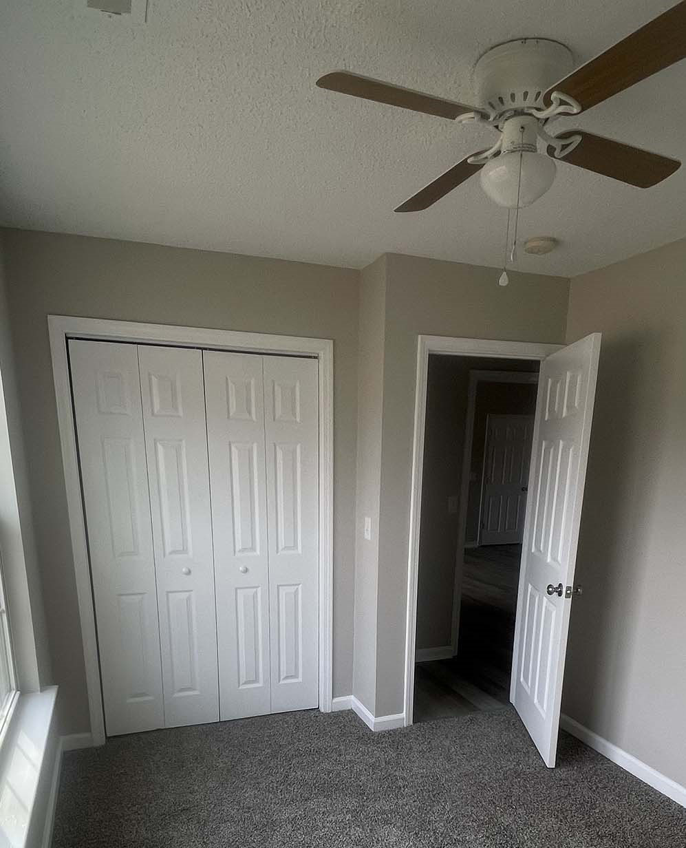 Interior bedroom with access door and closet door painted white, walls are painted gray
